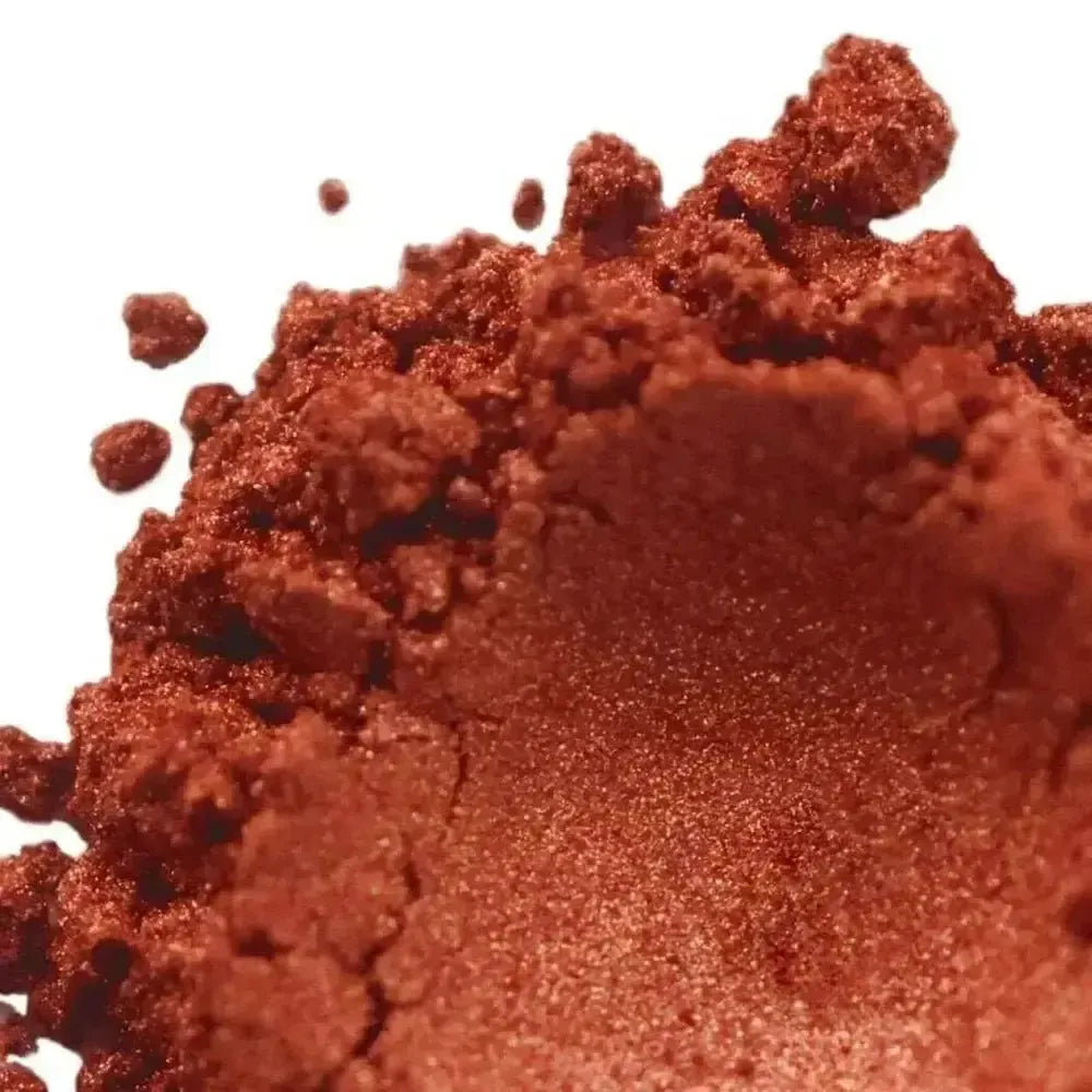 Heaped burnt copper orange mica powder with metallic shimmer