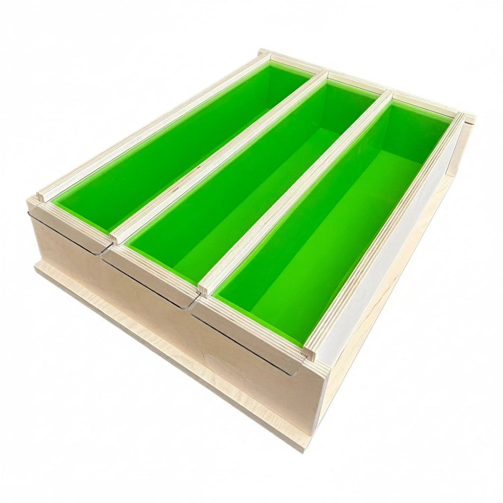 Wooden mold holding three bright green silicone liners side by side