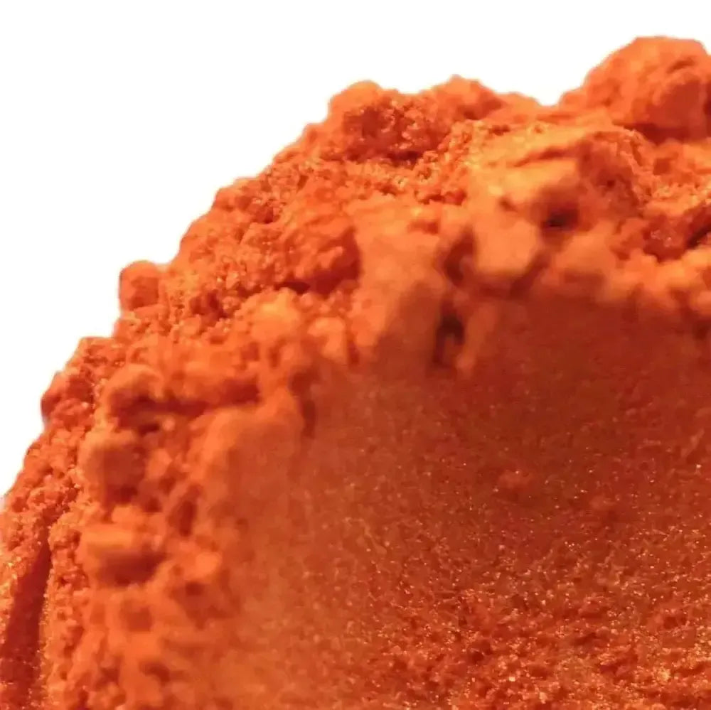 Vibrant Atomic Orange Mica powder mound with granular shimmer