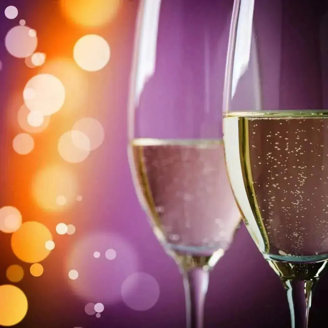 Two elegant champagne flutes with golden bubbly liquid in Champagne Fragrance Blend
