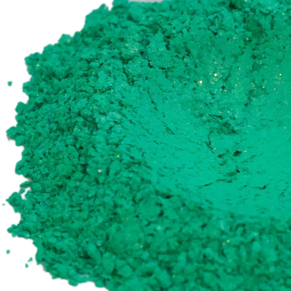 Mound of jade green mica powder with slight gold sparkle