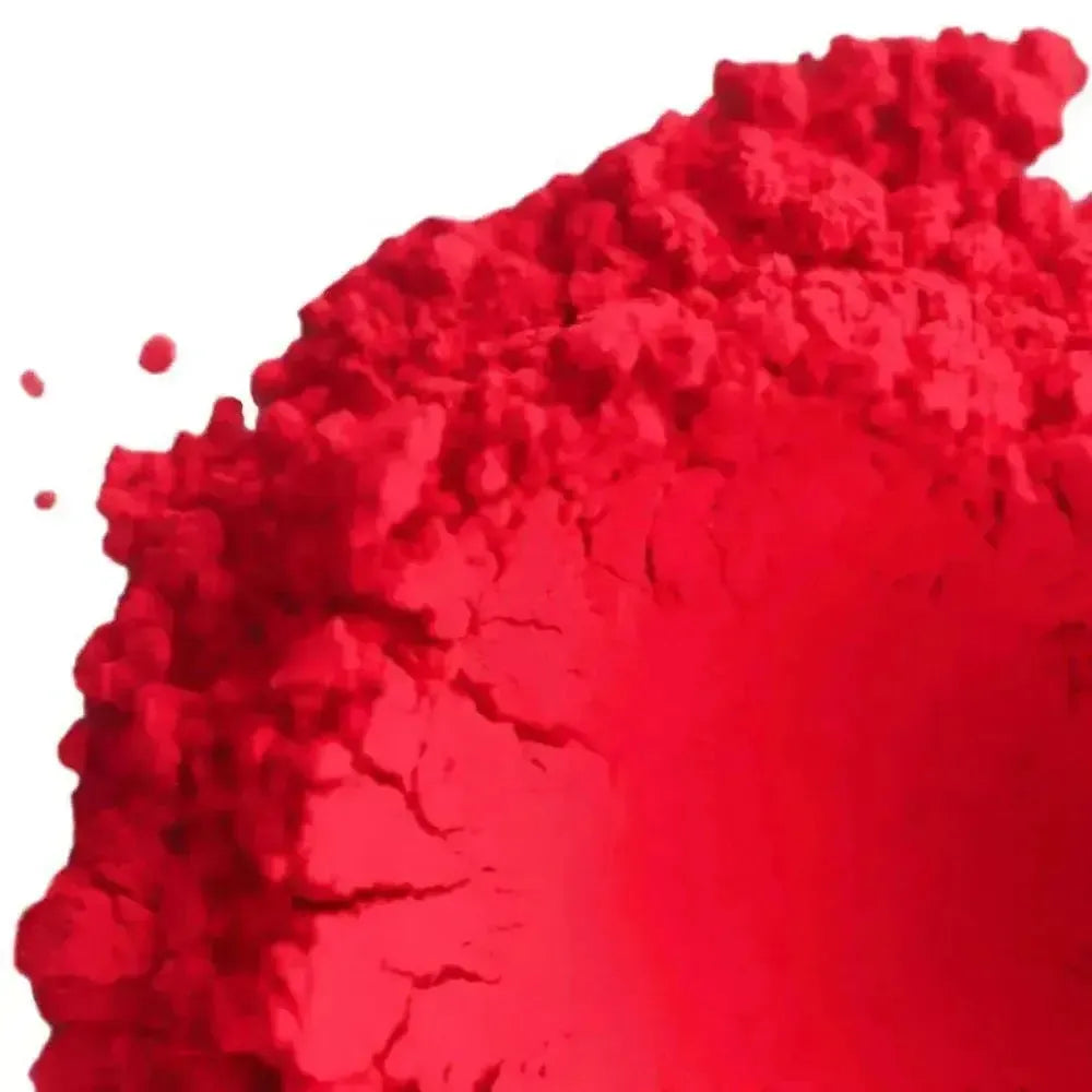 Vibrant fluorescent neon red pigment powder with crumbly texture
