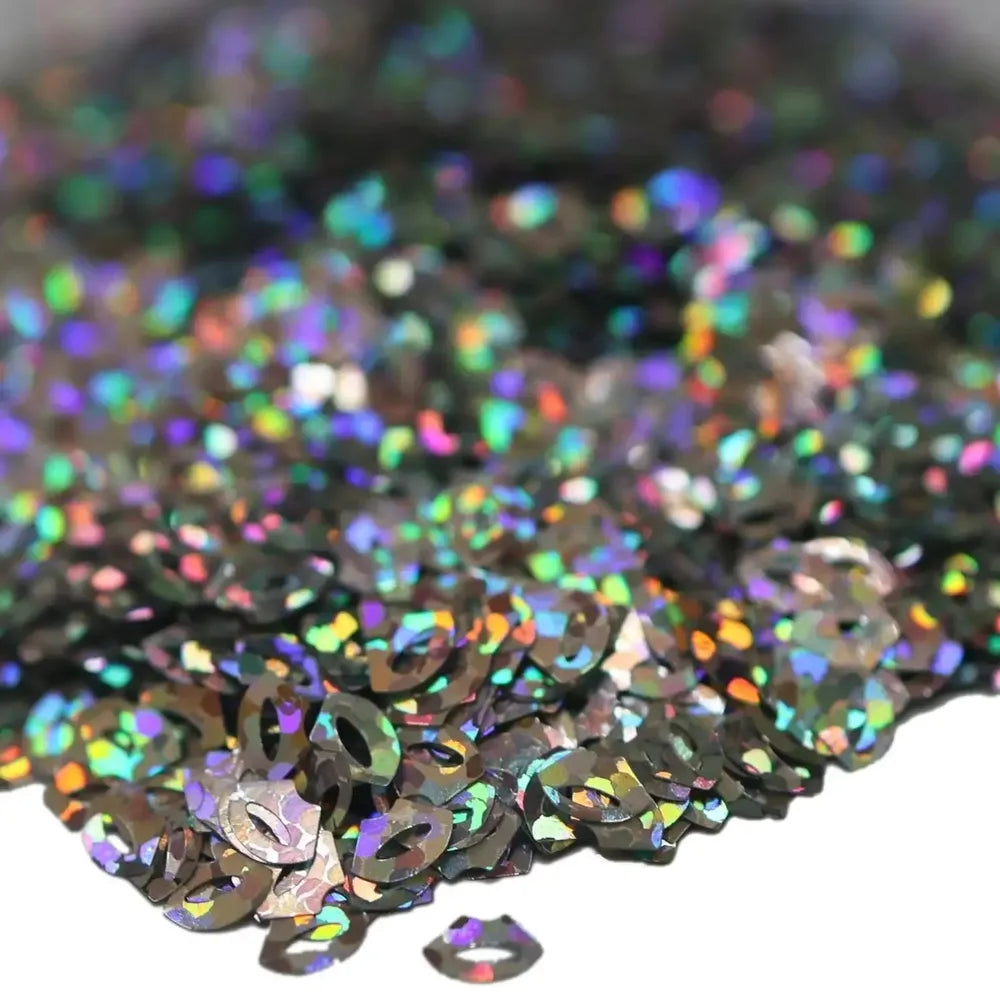 Close-up of Lip Service Biodegradable Glitter, shiny lip-shaped pieces reflecting rainbow colors, eco-friendly crafting.
