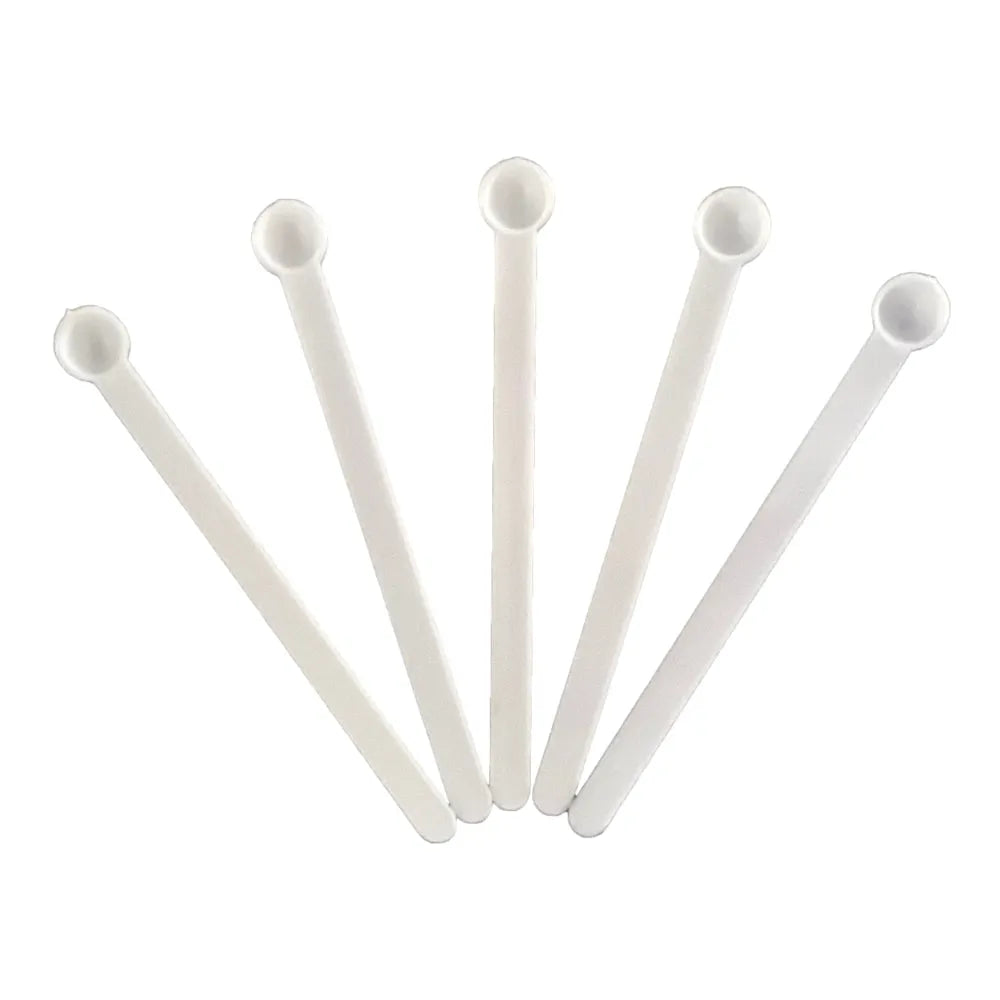 Five white plastic micro scoops fanned on white background