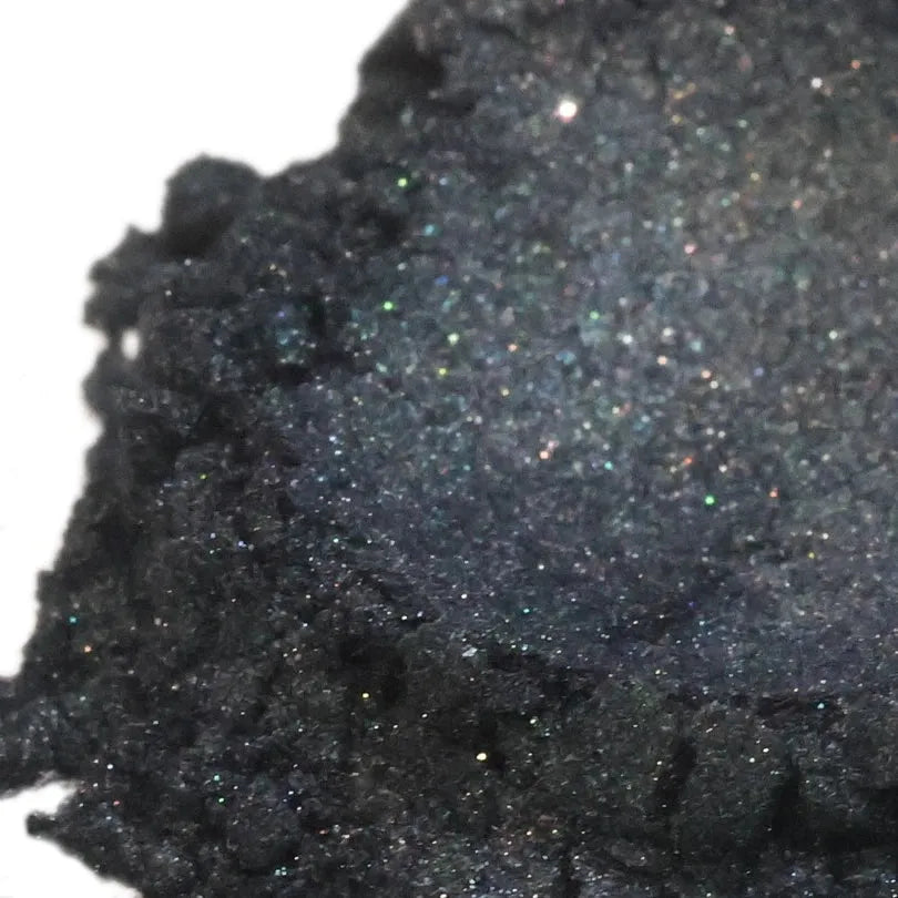 Heaped black mica powder with fine silver and green sparkle