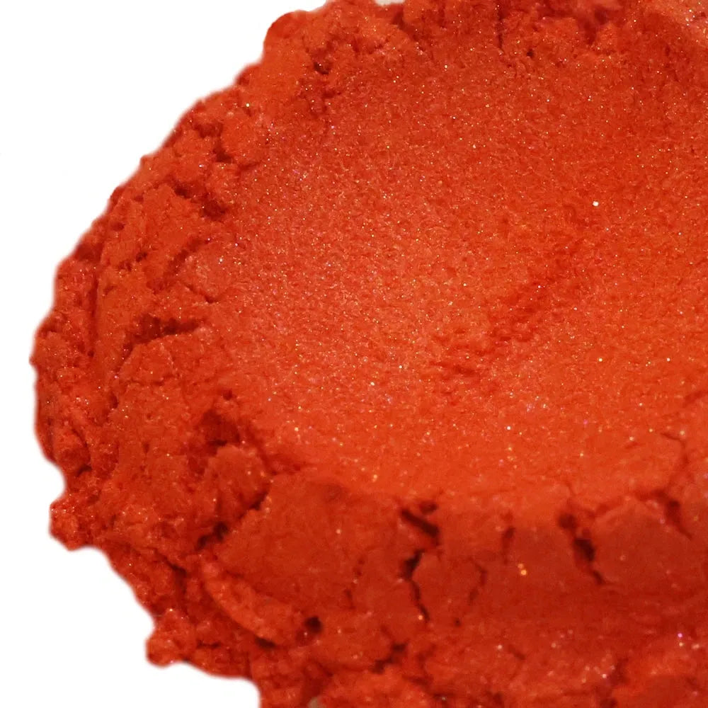 Mound of deep red-orange mica powder with fine shimmer