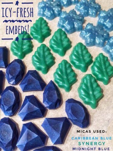 Icy-fresh soap embeds with green leaves and blue gems using Caribbean Blue, Synergy, and Midnight Blue micas by Nurture Handmade.