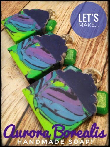 Aurora Borealis handmade soap bars with vibrant swirl patterns in green, blue, and purple colors on a wooden surface.