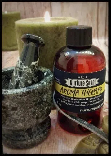 Aromatic soap-making setup featuring Nurture Soap's Aroma Therapy bottle, pestle, and candles.