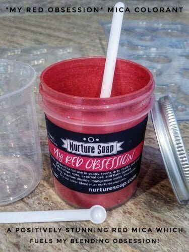 Nurture Soap "My Red Obsession" mica colorant with stirring tool showcasing vibrant red mica in an open container for soap making.