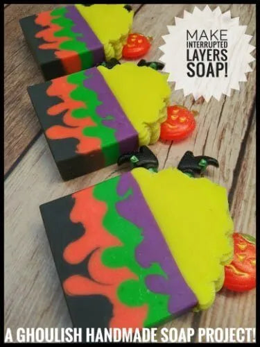 Colorful interrupted layers of ghoulish handmade soap with Halloween themes, perfect for spooky crafting!