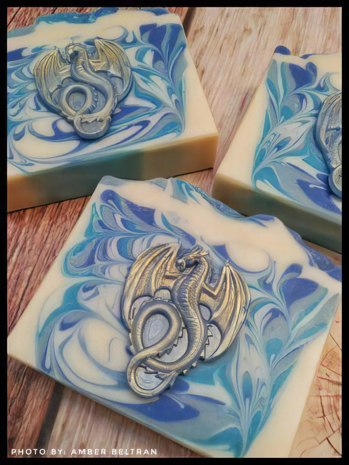 Blue and white swirled soap bars topped with silver dragon medallions