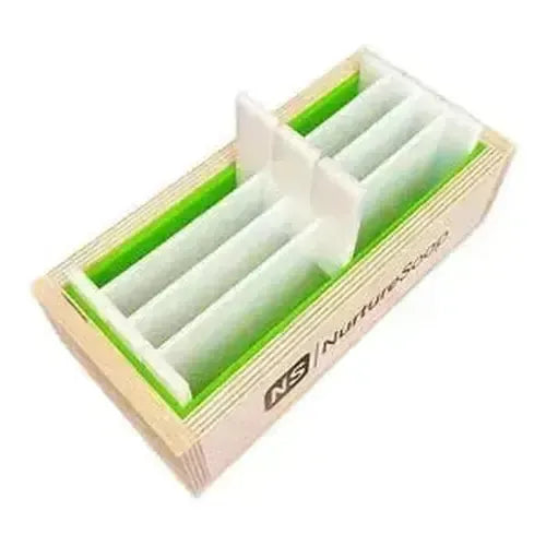 Wooden soap mold with green lining and dividers for crafting custom soap bars.