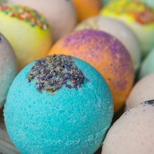Colorful bath bombs with vibrant dyes and eco-friendly glitter, showcasing a variety of delightful designs.