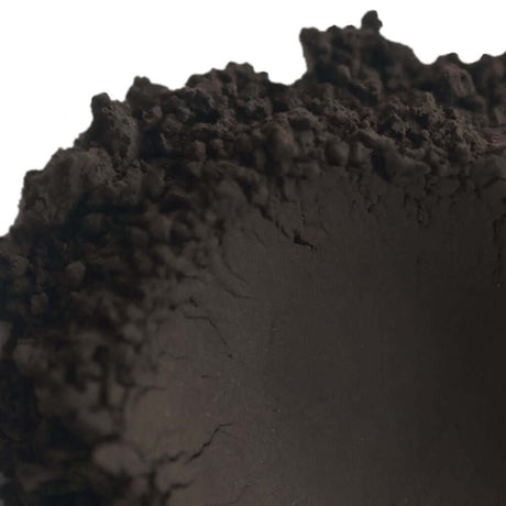 Natural black clay powder for soap making with earthy texture.