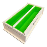 Handmade wooden soap mold with green silicone liner for nurturing homemade soap making.