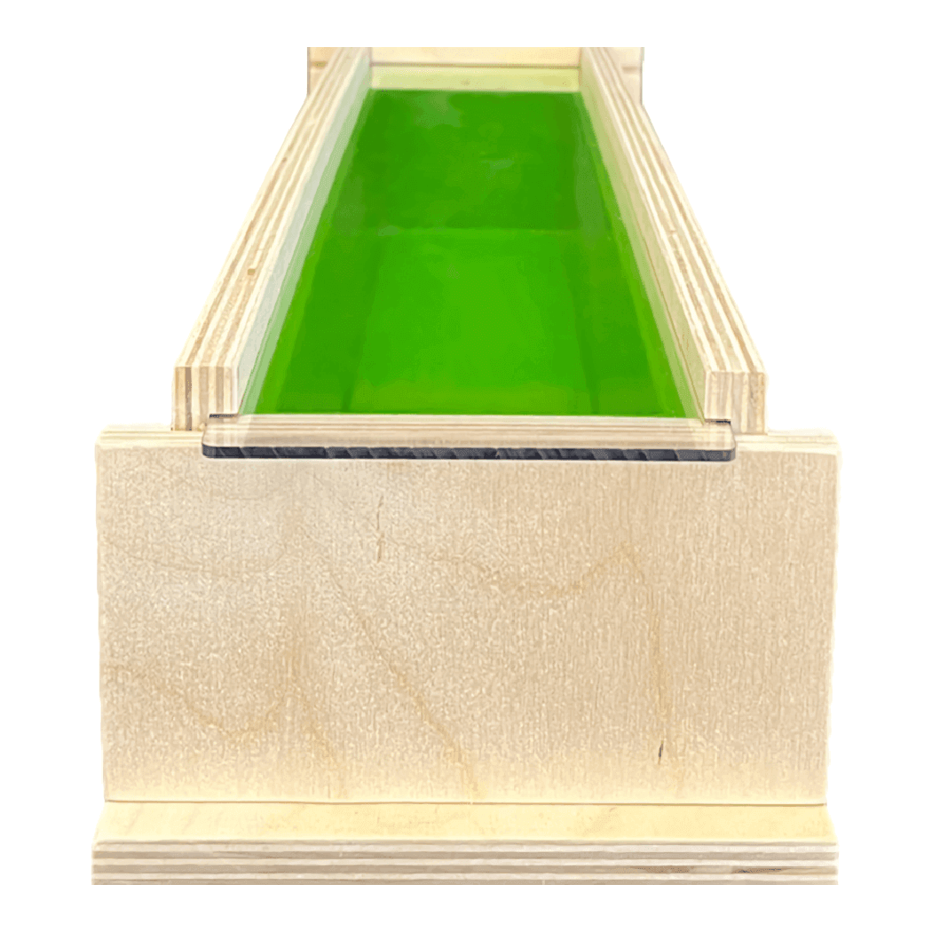 Handmade wooden mold box for soap making with green interior, ideal for nurturing and crafting homemade soaps.