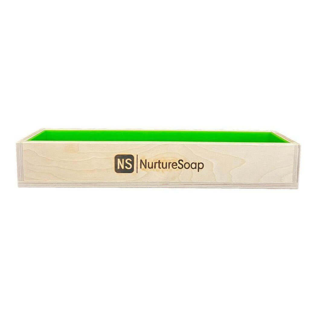 Wooden soap mold from Nurture Soap with a green interior, perfect for handmade soap crafting and nurturing creativity.