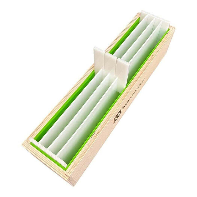 Wooden soap mold with green interior and white dividers for handmade soap making by Nurture Handmade.