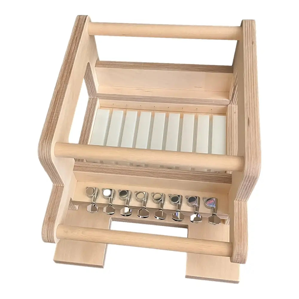 Wooden soap cutter frame, tensioner row and white soap bars inside