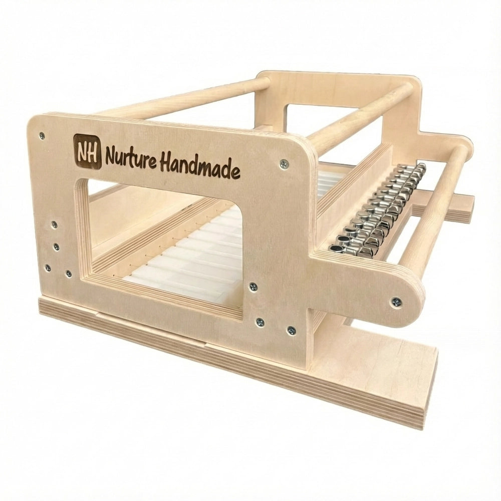 Light wood frame with rods and metal components designed for weaving or crafting, labeled Nurture Handmade.