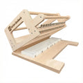 Wooden soap cutter with metal strings and tuners on a white background