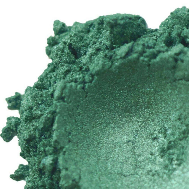 Close-up of lush green handmade cosmetic powder showcasing its rich texture and vibrant color.