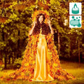 Woman in golden satin gown with autumn leaf cape for Artemis Fragrance Blend