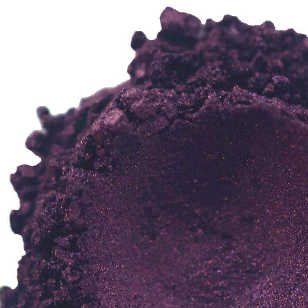 Close-up of dark purple powdered pigment showcasing its texture and rich color for Nurture Handmade products.