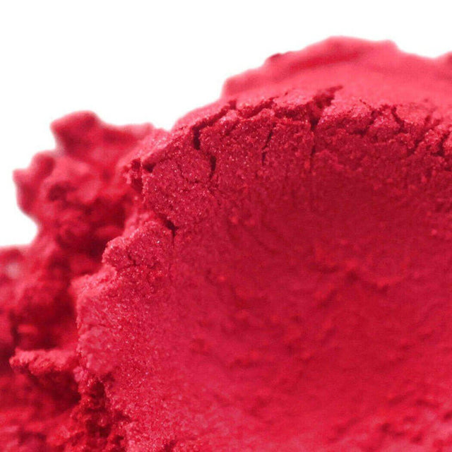 Close-up of vibrant red handmade powder eyeshadow, texture emphasizes the Nurture Handmade brand quality and craftsmanship.