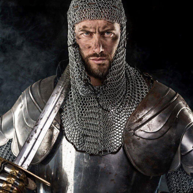 Medieval knight in chainmail and armor holding sword.