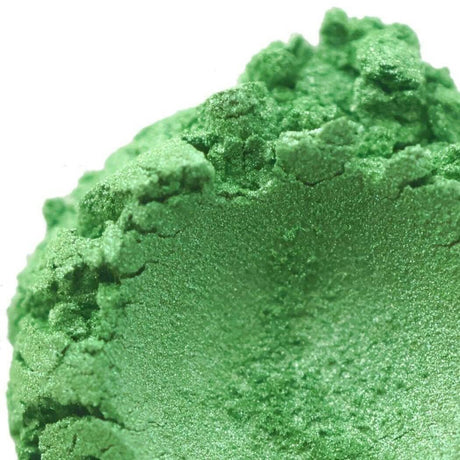 Close-up of vibrant green handmade pigment powder. Nurture Handmade sustainable beauty products.