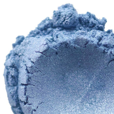 Shimmering blue makeup powder showcasing Nurture Handmade cosmetics.