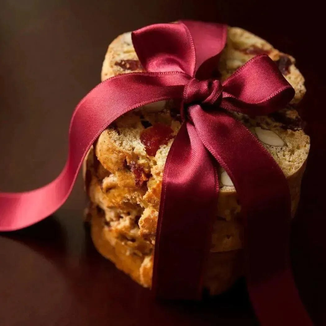 Golden-brown biscotti stack tied with burgundy ribbon for Cherry Almond Fragrance Oil