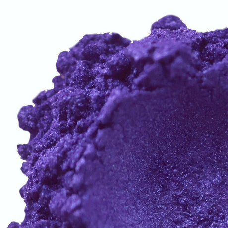 Close-up of vibrant purple handmade eyeshadow powder, highlighting its rich texture and pigment. Nurture Handmade beauty product.