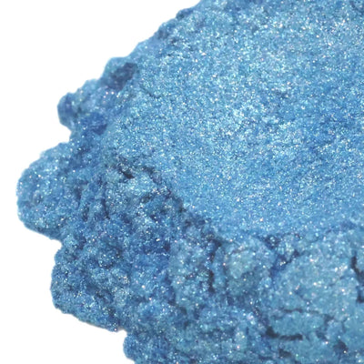 Mound of mid-blue mica powder with dense silvery sparkle