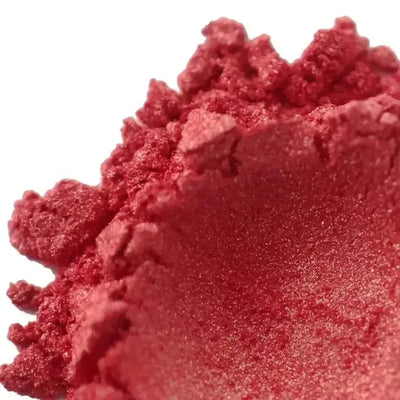 Mound of coral red mica powder with pink shimmer