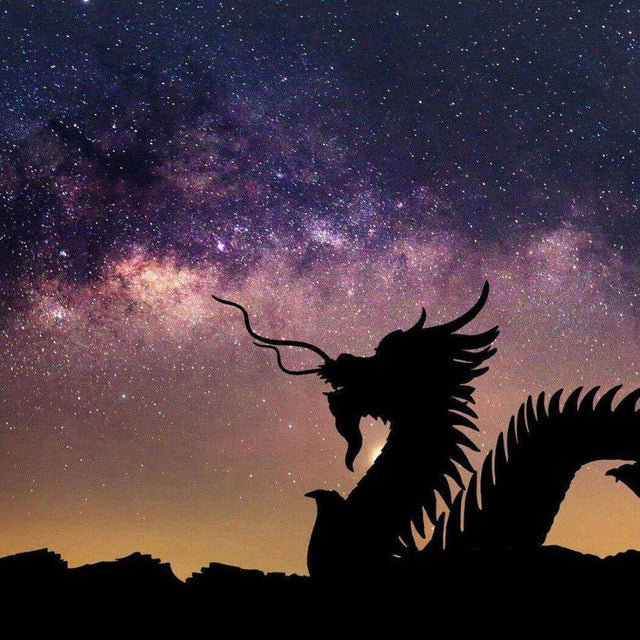 Silhouette of a dragon against a starry night sky with the Milky Way in the background