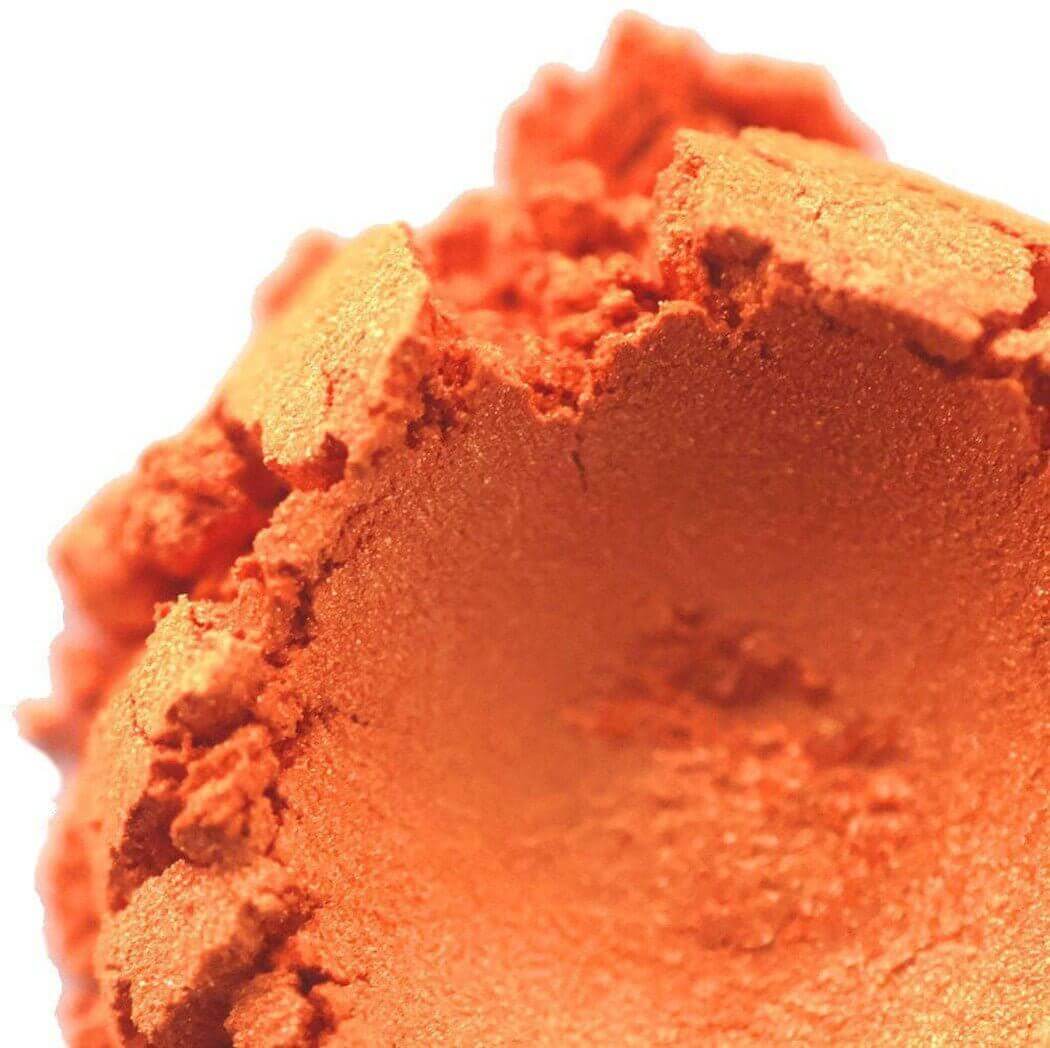 Close-up of vibrant orange powder pigment from Nurture Handmade.