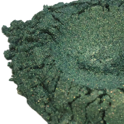Heaped dark forest green mica powder with golden glitter