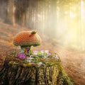 Whimsical red-capped mushroom house on mossy stump for Fairy Garden Fragrance Oil
