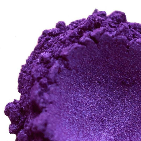 Close-up of vibrant purple handmade eyeshadow with a textured finish. Keywords: Nurture Handmade.