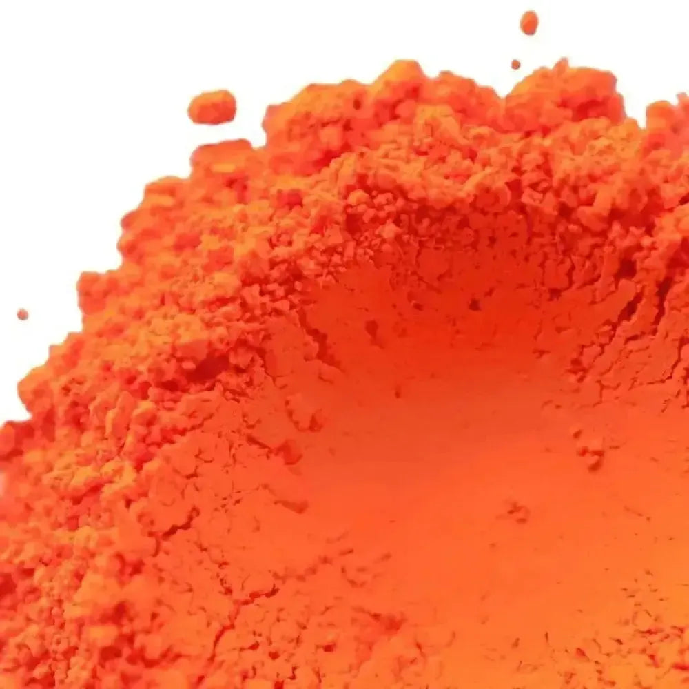 Vibrant fluorescent neon orange pigment powder with fine granular texture