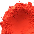 Vibrant fluorescent neon red-orange pigment powder with fine crumbly texture