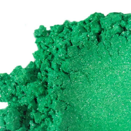 Close-up view of vibrant green loose eyeshadow powder, highlighting its texture and shimmer, perfect for Nurture Handmade beauty products.