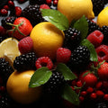 Vibrant assortment of fresh fruits including lemons, strawberries, blackberries, raspberries, and green leaves.