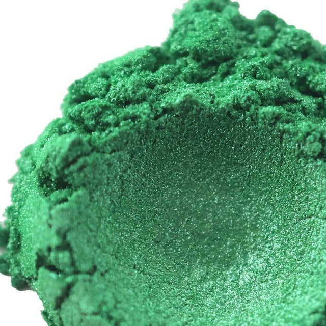 Shimmering green eyeshadow powder with a textured surface, highlighting Nurture Handmade cosmetics for a bold and vibrant look.