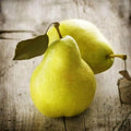Two ripe yellow-green pears with stems on wood for Juicy Pear Fragrance Oil