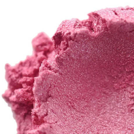 Close-up of pink handmade cosmetic product with a smooth, creamy texture showing fine details of its surface. Nurture Handmade beauty item.