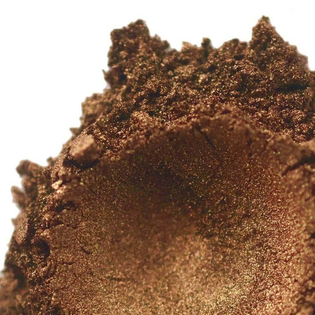 Close-up of brown shimmer eye shadow powder with a rich texture.